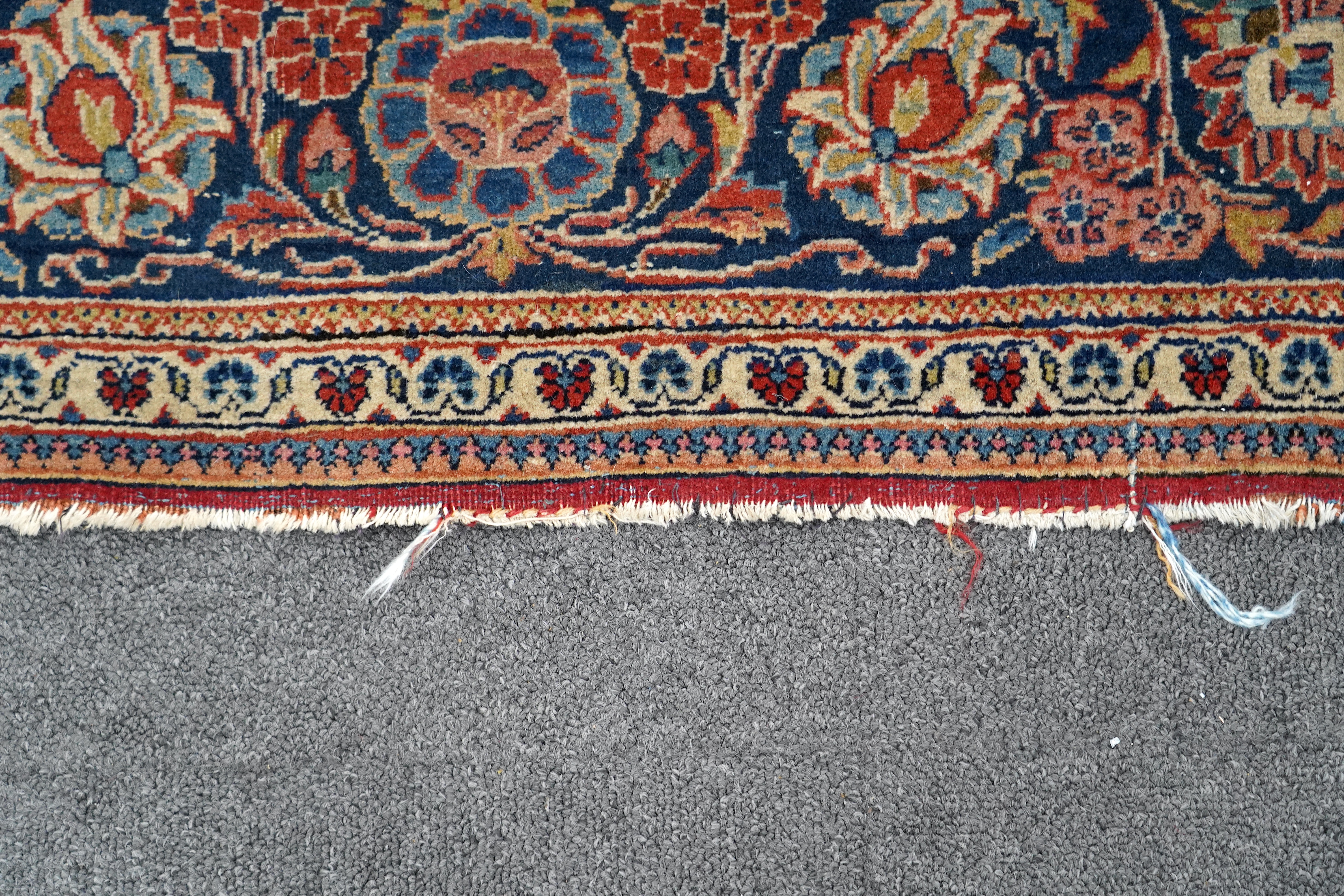 A pair of antique Tabriz brick red ground rugs, 200 x 136cm. Condition - fair